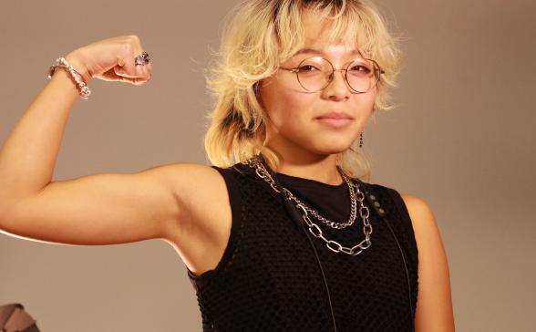 a photo of Bennie with their arm raised in a body builder pose. 