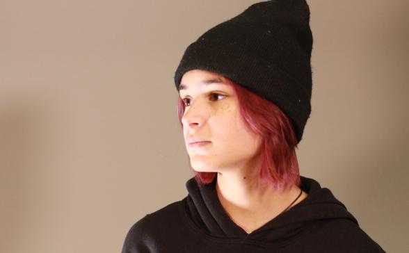 a photo of Izzy with a gray background. 