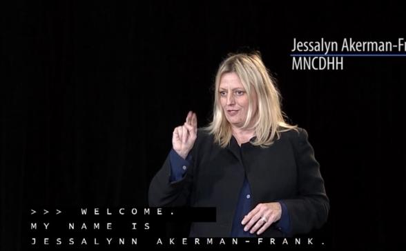 This still shot of the video is off Jessalyn signing a welcome to ASL viewers. 