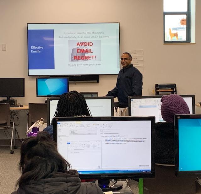 A CTEP member presents and teaches a classroom of students about email